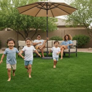 Professionally installed artificial turf lawn in Phoenix with a family enjoying outdoor activities